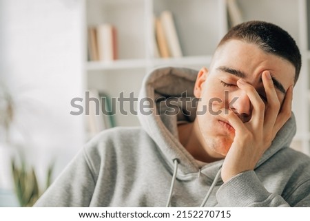 portrait of young teenager with bored or overwhelmed expression Royalty-Free Stock Photo #2152270715