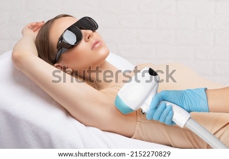 Elos epilation hair removal procedure on a woman’s body. Beautician doing laser rejuvenation in a beauty salon. Removing unwanted body hair. Hardware ipl cosmetology Royalty-Free Stock Photo #2152270829