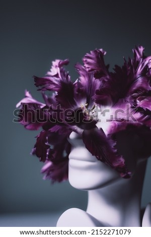 Fresh bunch of purple parrot tulips in vase in shape of womens face on light background. Trendy Ceramic Vase of human head, Handmade Modern Statue Art Flower Vase. Card Concept, copy space for text Royalty-Free Stock Photo #2152271079
