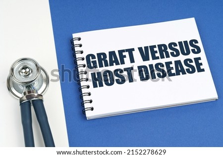 Medical concept. On a blue-white surface lies a stethoscope and a notepad with the inscription - Graft Versus Host Disease Royalty-Free Stock Photo #2152278629