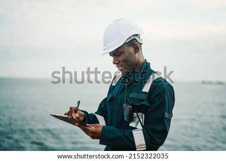 African American seaman filling checklist during work Royalty-Free Stock Photo #2152322035