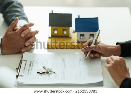 Close up Business woman or Real Estate agent explain signing agreement for buying house. Bank manager and real estate concept