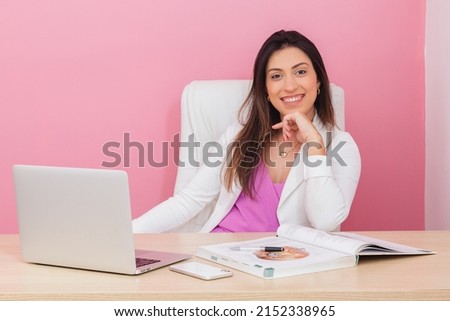 beautician doctor, successful entrepreneur woman, professional portrait, beautician, aesthetic, businesswoman. At a table with a notebook. with hand on chin. smiling. Royalty-Free Stock Photo #2152338965