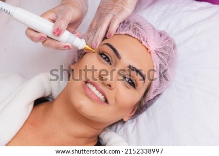 close-up of facial plasma jet on patient, Application of aesthetic procedure, rejuvenation. Royalty-Free Stock Photo #2152338997