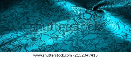 blue silk fabric with a floral pattern, unusually pleasant visual sensations: slippery, coolness, softness; beautiful appearance, unique shine;