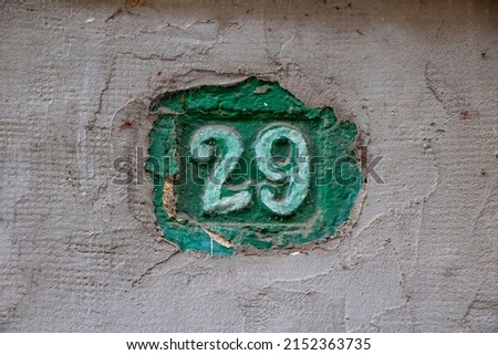 House number twenty-nine on a wall. Number 29 door sign.