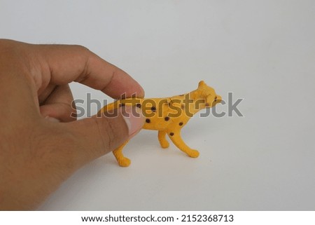 Yellow leopard shaped toy made of plastic photo