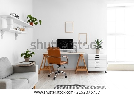 Light interior of room with comfortable workplace and modern computer Royalty-Free Stock Photo #2152376759