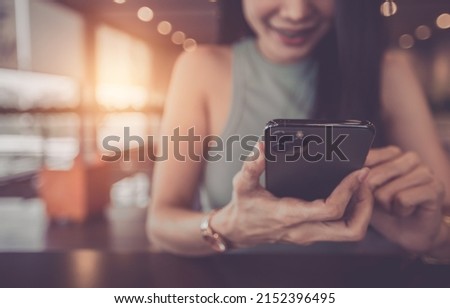 person using smartphone in cafe