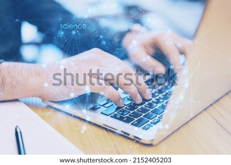 Close up of hands using laptop keyboard on office desktop with creative digital linear sphere on blurry background. Global network and communication concept. Double exposure