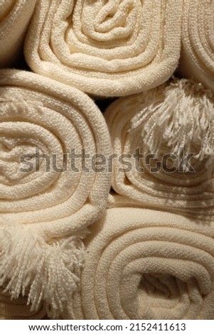 details of the surface of the blanket made of cotton for body warmth. cream colored and rolled