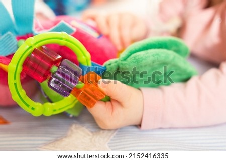 Toodler baby playing with toys, close up picture, hands only