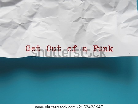Crumpled paper with text GET OUT OF A FUNK on copy space blue background - means getting back from feeling depressed, out of control or overly emotional, take off-day and turn it to a productive one Royalty-Free Stock Photo #2152426647