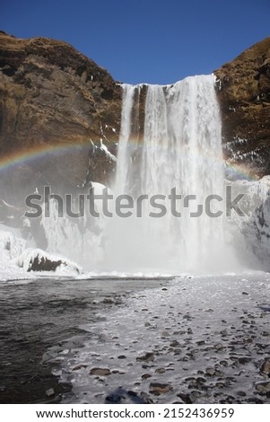 Close up of a beautiful rainbow created by sun rays stiking water droplets created by the water jet of the amazing Skogafoss waterfall in the south of Iceland, Europe