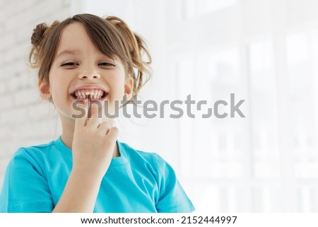The kid lost a tooth. Baby without a tooth. Portrait of a little girl no tooth. High quality photo Royalty-Free Stock Photo #2152444997