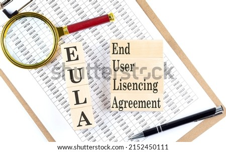 EULA - End User Licensing Agreement text on wooden block on a chart background