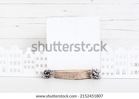 Mockup of a white wooden sign. White square sign on a light background with cones and toy houses.