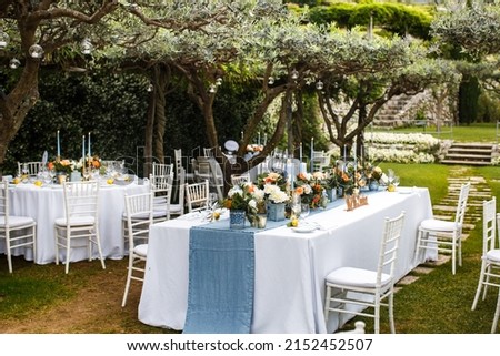 Table set for wedding or another catered event dinner in the garden Royalty-Free Stock Photo #2152452507