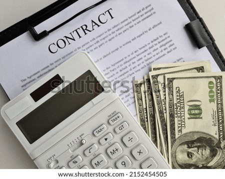 Business contract one hundred dollar bills and calculator. Business agreement and business profit concept