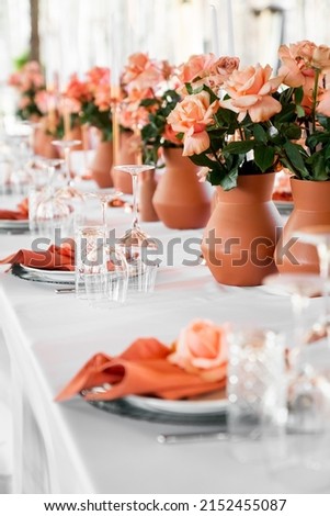 Beautiful table decoration with orange roses
