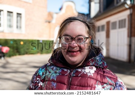 Close up outdoor portrait of a 39 year old white woman with Down Syndrome