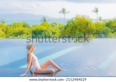 Portrait beautiful young asian woman enjoy around outdoor swimming pool with sea ocean view