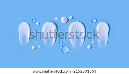 cosmetic smears cream texture on pastel blue background Royalty-Free Stock Photo #2152501863
