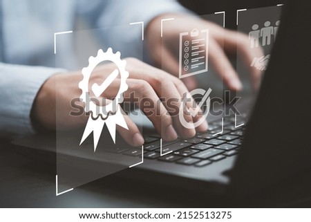 Businessman using laptop computer with quality assurance and document icon for ISO or International Standard Organisation which related quality control and continuous improvement concept. Royalty-Free Stock Photo #2152513275