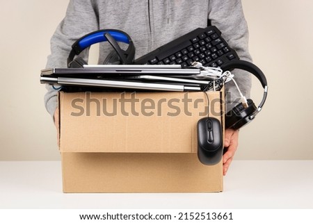 Woman hands holding cardboard box full old used computers, phones, tablets, gadget devices for recycling. Planned obsolescence, e-waste, donation, electronic waste for reuse and recycle concept Royalty-Free Stock Photo #2152513661