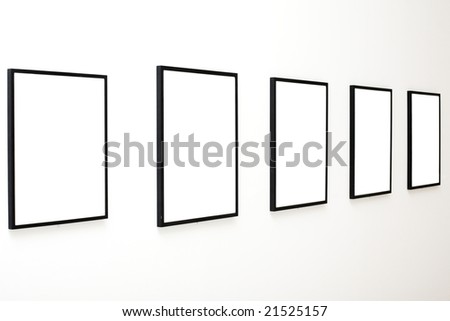Five empty frames on white wall exhibition in Museum