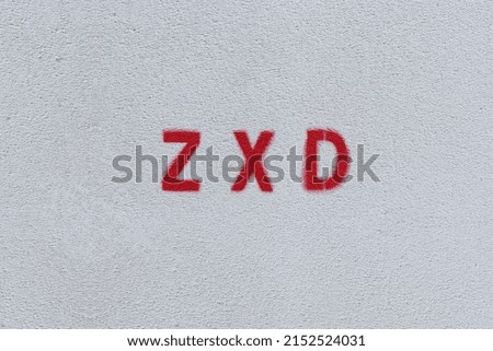 RED ZXD on the white wall. Spray paint.
