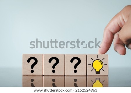 Creative Idea and Innovation Concept.,Selective Focus Hand touching on light bulb icon on wooden cube over white background.
