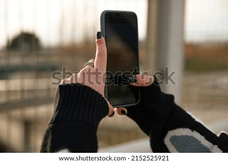 Hands of a girl taking photos with a smartphone