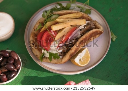 Greek chicken souvlaki ona pita with fresh vegetables with tzatziki sauce