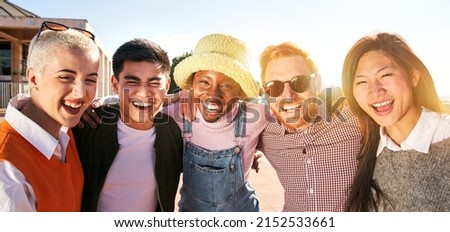 Smiling panoramic portrait of cheerful group of young people. Happy friends excited having fun. Interracial boys and girls taking picture looking at camera smart mobile phone. Enjoying vacations