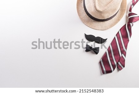 Happy Fathers Day background concept with hat, gift box, necktie and mustache on white background. Royalty-Free Stock Photo #2152548383