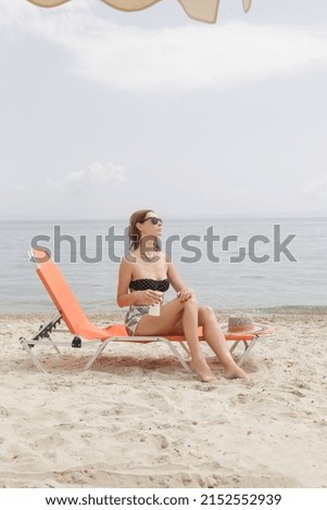 Woman applying sunscreen cream on her legs. Sun protection skin care concept.	
