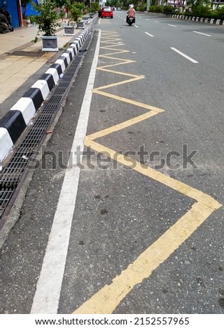 blurred background, zig zag line mean motorcycle  parking area. it's side of the road city. Royalty-Free Stock Photo #2152557965