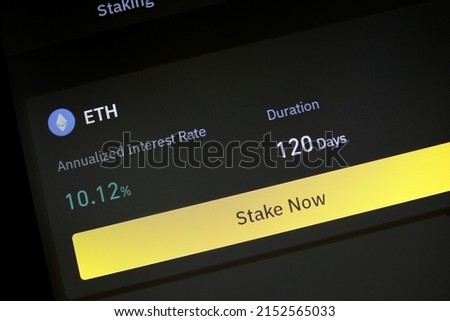 App with function to stake Ethereum for fixed interest rate and period. App allowing cryptocurrency hodlers to stake cryptos to earn rewards or interests on their holdings. Phone screen closeup view. Royalty-Free Stock Photo #2152565033