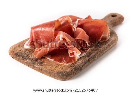 Spanish serrano ham on cutting board isolated on white background Royalty-Free Stock Photo #2152576489