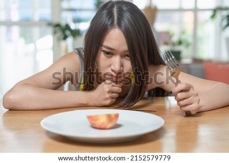 unhappy woman eat a small meal during diet