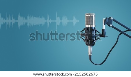 Radio microphone isolated on blue background, concept of podcast, online radio, streaming, entertainment, audio, and communication. Royalty-Free Stock Photo #2152582675
