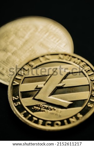 Close up shot of a golden Litecoin digital cryptocurrency, front and back.