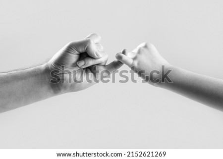 Show friendship and forgiveness. Friendship of generations. Father, daughter hand making promise friendship concept. Child hook little finger together. Black and white. Royalty-Free Stock Photo #2152621269