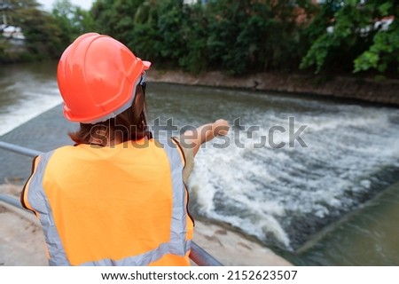 Asian Female engineering working 
 at sewage treatment plant,Marine biologist analysing water test results,World environment day concept Royalty-Free Stock Photo #2152623507