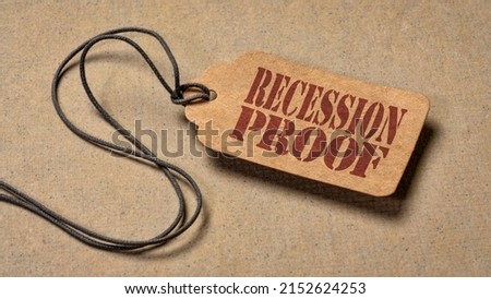 recession proof  - red stencil text on a paper price tag against textured paper, marketing slogan Royalty-Free Stock Photo #2152624253