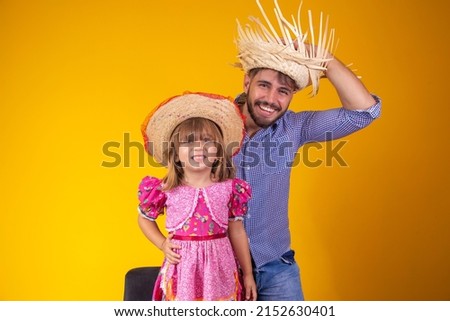 Father and daughter dressed in June party clothes. Young daddy and little daughter ready for june party. Copy space 