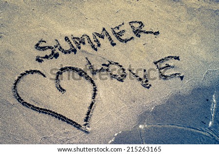 heart and summer love words drown into sand on beach