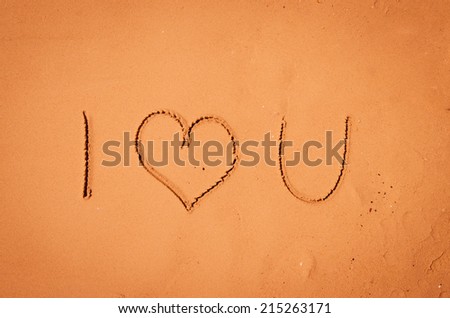 i love you written into sand on beach