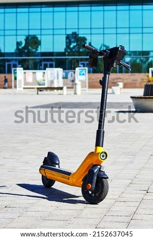 electric scooters for rent on the sidewalk of downtown area Royalty-Free Stock Photo #2152637045